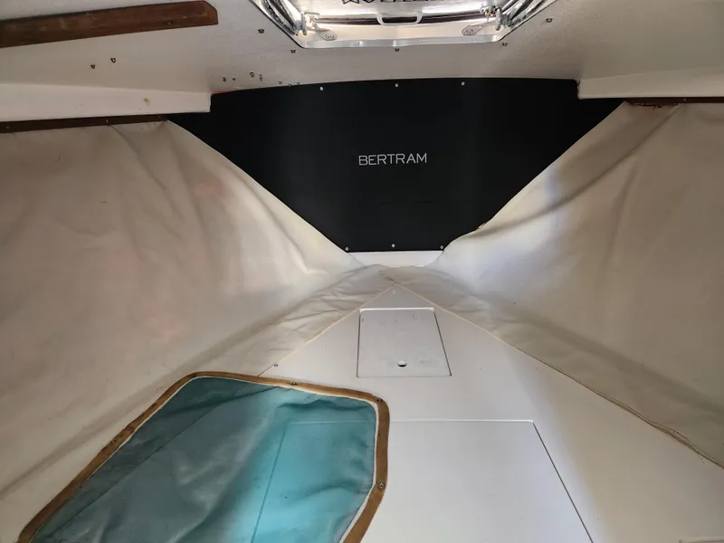 Slide: The Image of 1975 Bertram 28 Flybridge Cruiser cabin interior with white upholstery and Bertram logo. - 8