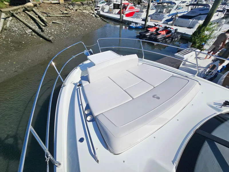 Slide: The Image of 2024 Beneteau Antares 12 boat with sunbathing deck, docked in marina. - 23