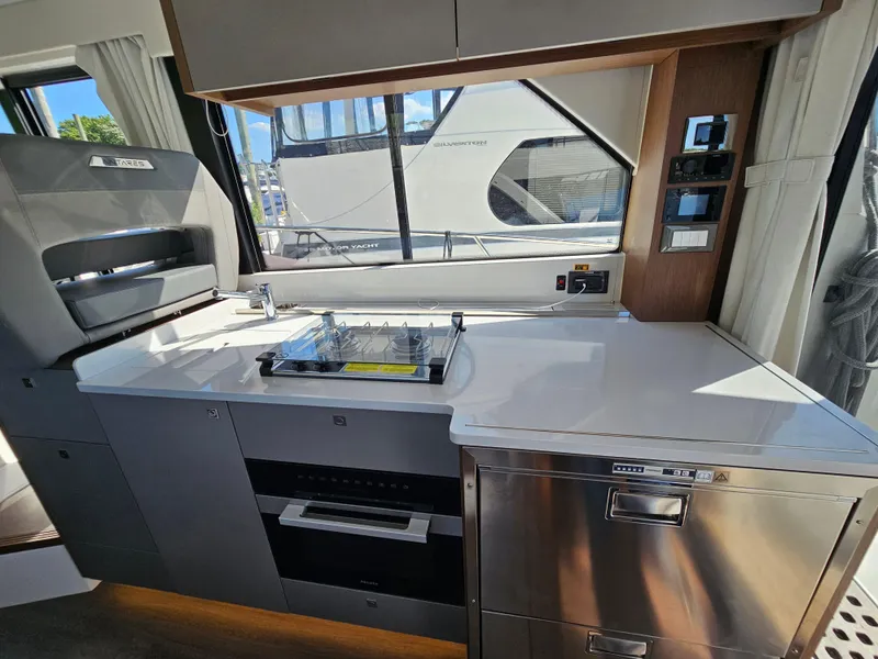 Slide: The Image of Modern kitchen interior of 2024 Beneteau Antares 12 yacht with stove and oven. - 24
