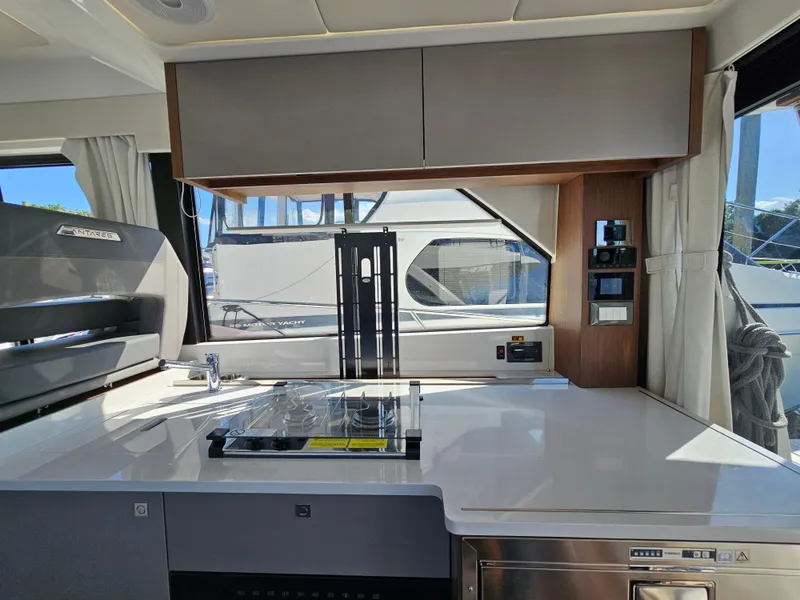 Slide: The Image of Interior of 2024 Beneteau Antares 12 yacht, featuring modern kitchen and control panel. - 25