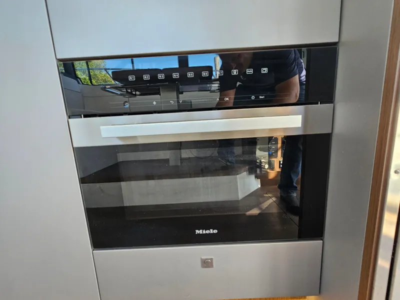 Slide: The Image of Modern Miele oven in 2024 Beneteau Antares 12 yacht kitchen. - 26