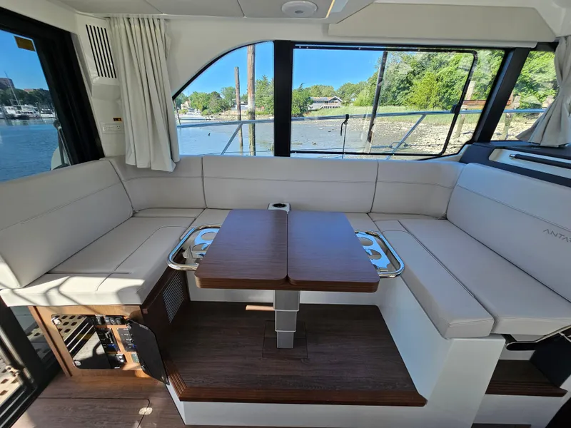 Slide: The Image of Luxurious interior of 2024 Beneteau Antares 12 yacht with elegant seating and scenic window views. - 28