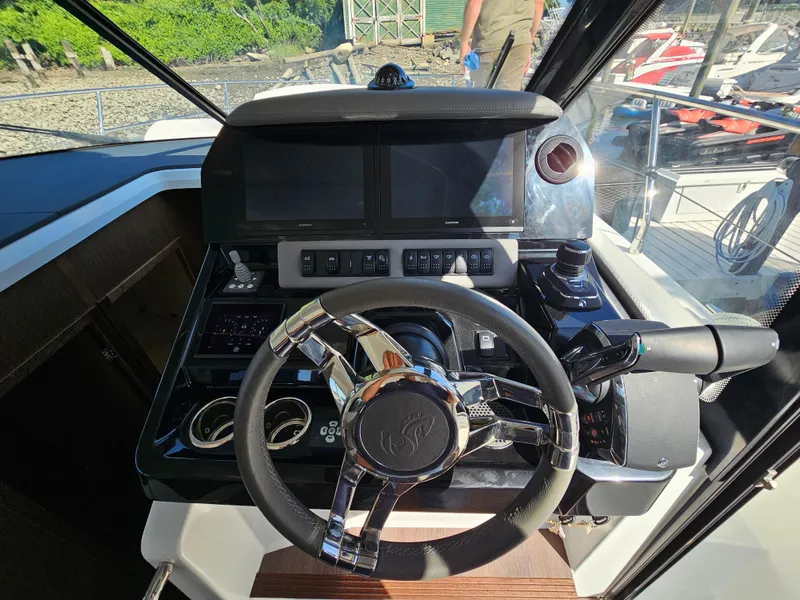 Slide: The Image of Helm of 2024 Beneteau Antares 12 with modern controls and navigation screens. - 34