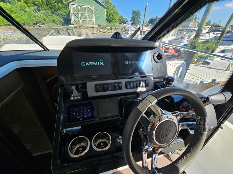 Slide: The Image of 2024 Beneteau Antares 12 helm with Garmin navigation system and modern controls. - 35