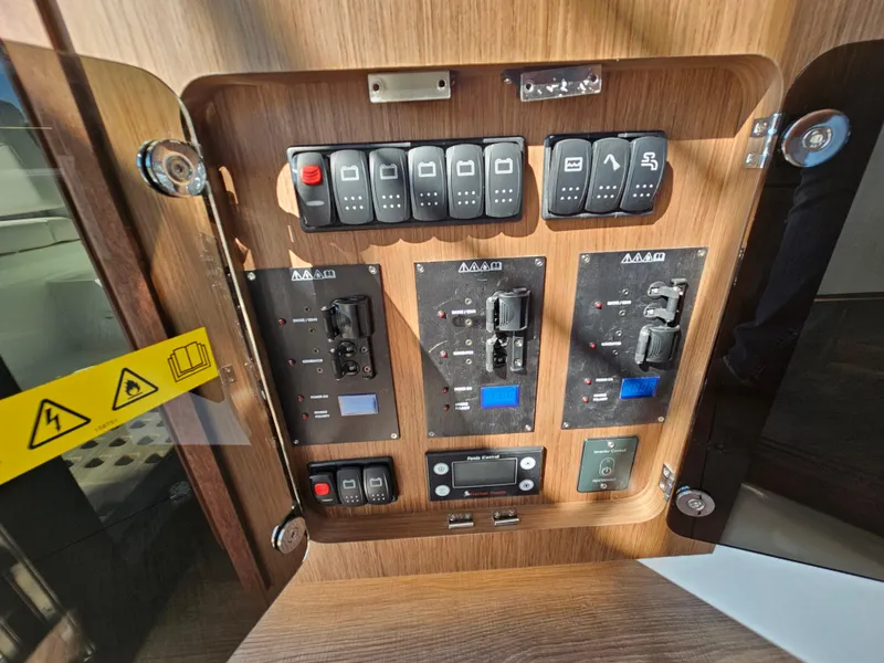 Slide: The Image of Electrical control panel on 2024 Beneteau Antares 12 boat, featuring switches and indicators. - 37