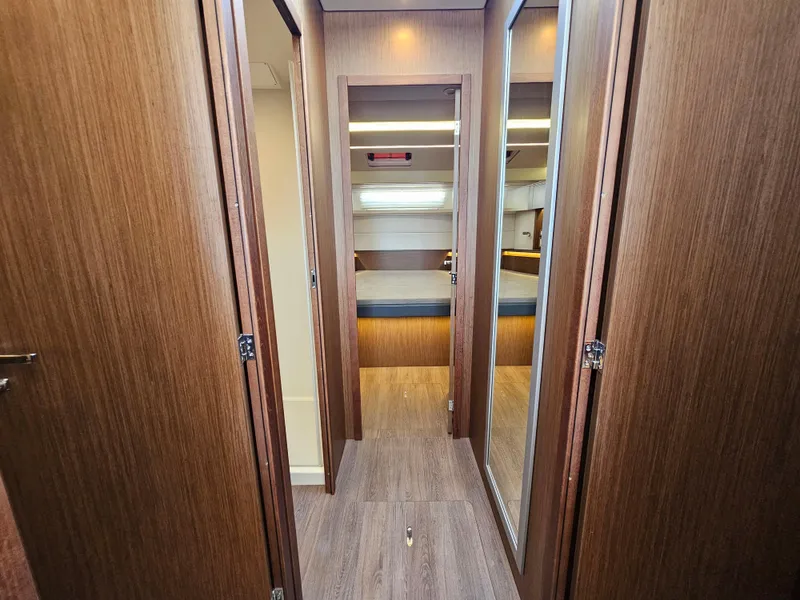 Slide: The Image of 2024 Beneteau Antares 12 interior cabin with wood finish and modern design. - 38