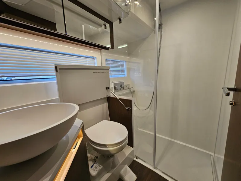 Slide: The Image of Modern bathroom in 2024 Beneteau Antares 12 yacht with shower, sink, and toilet. - 41
