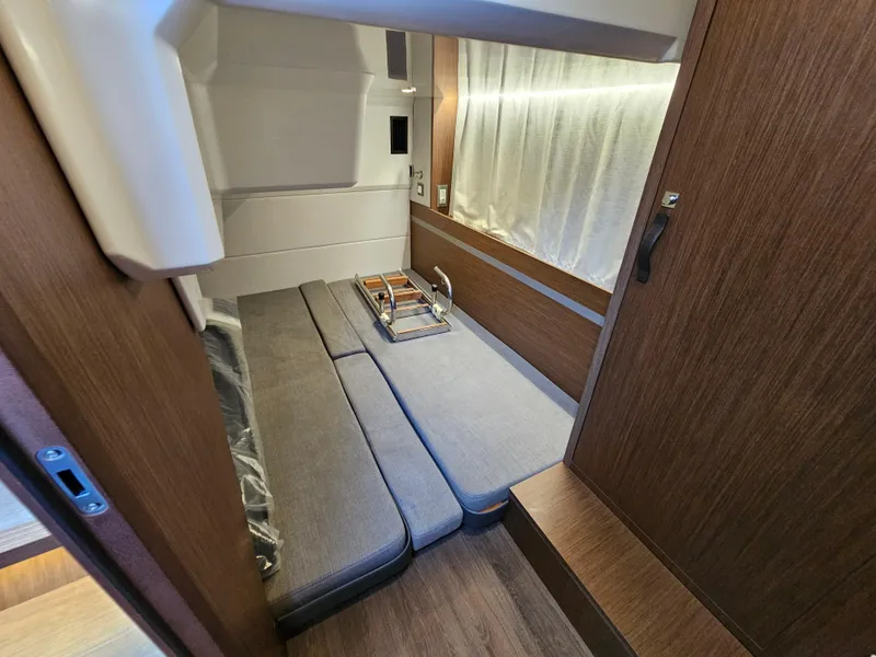 Slide: The Image of 2024 Beneteau Antares 12 cabin interior with modern wood finish and cozy seating. - 43