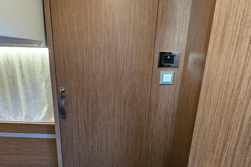 Slide: The Image of Interior of 2024 Beneteau Antares 12, featuring wooden paneling and modern controls. - 44