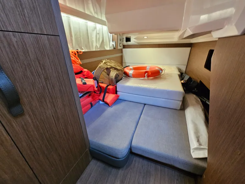 Slide: The Image of 2024 Beneteau Antares 12 cabin with life jackets and safety equipment. - 47