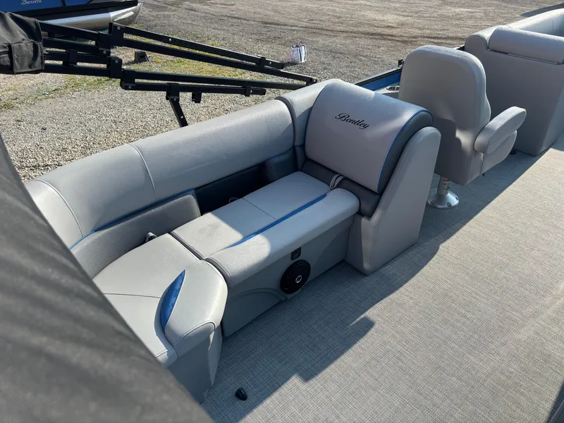 Slide: The Image of 2025 Bentley Pontoons Legacy Navigator interior with gray seating and blue accents. - 10