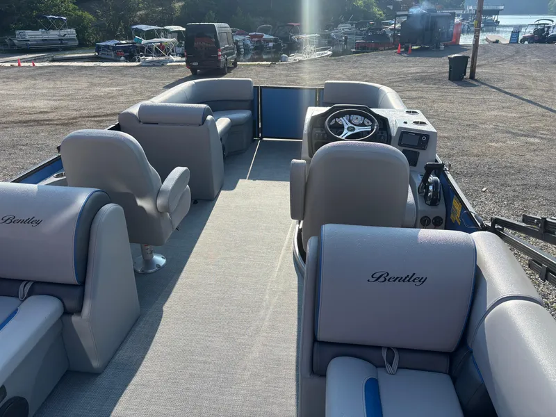 Slide: The Image of 2025 Bentley Pontoons Legacy Navigator interior with plush seating and modern dashboard. - 3