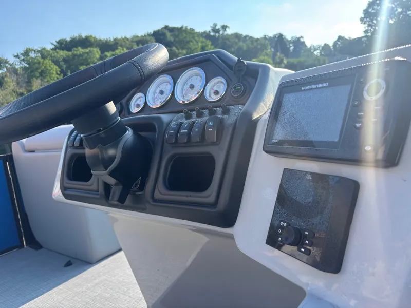 Slide: The Image of 2025 Bentley Pontoons Legacy Navigator dashboard with steering wheel and control panel. - 6