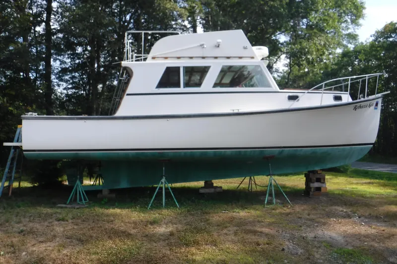 The Image of 2003 Duffy 35 Downeast Flybridge Cruiser on stands, surrounded by trees. - 0