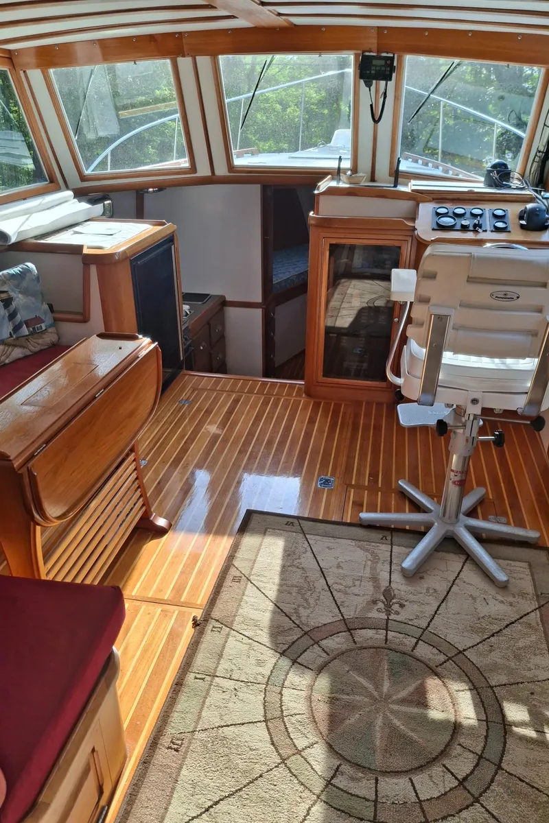 Slide: The Image of Interior of 2003 Duffy 35 Downeast Flybridge Cruiser with wooden flooring and helm station. - 13