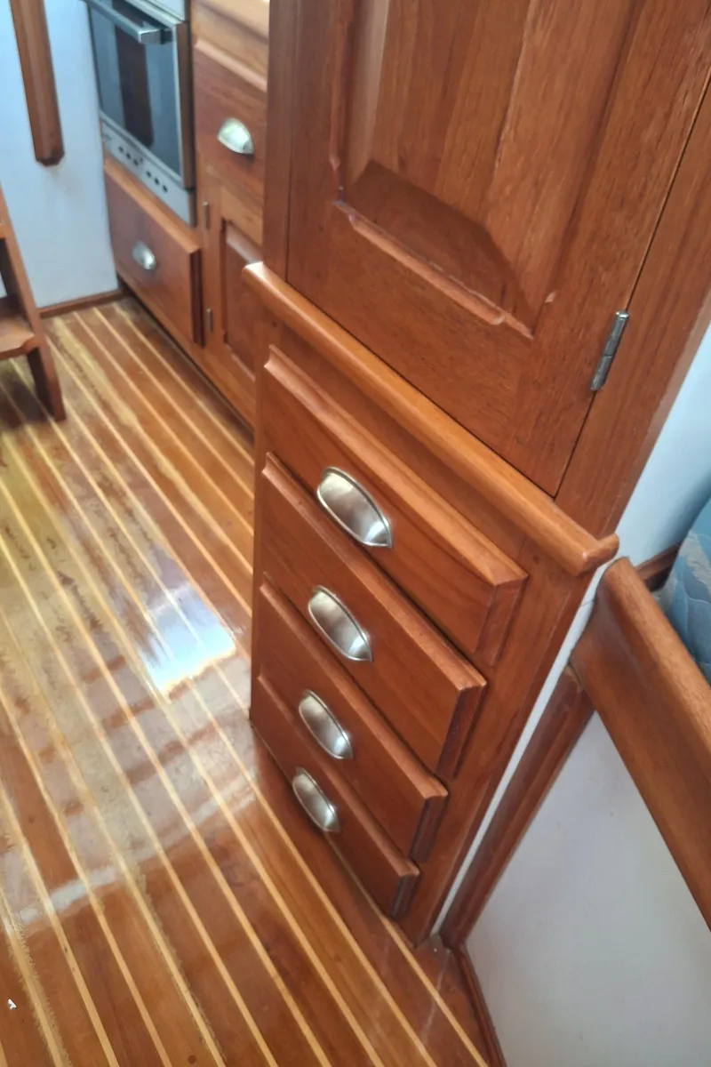 Slide: The Image of Interior of 2003 Duffy 35 Downeast Flybridge Cruiser with wooden cabinetry and flooring. - 15
