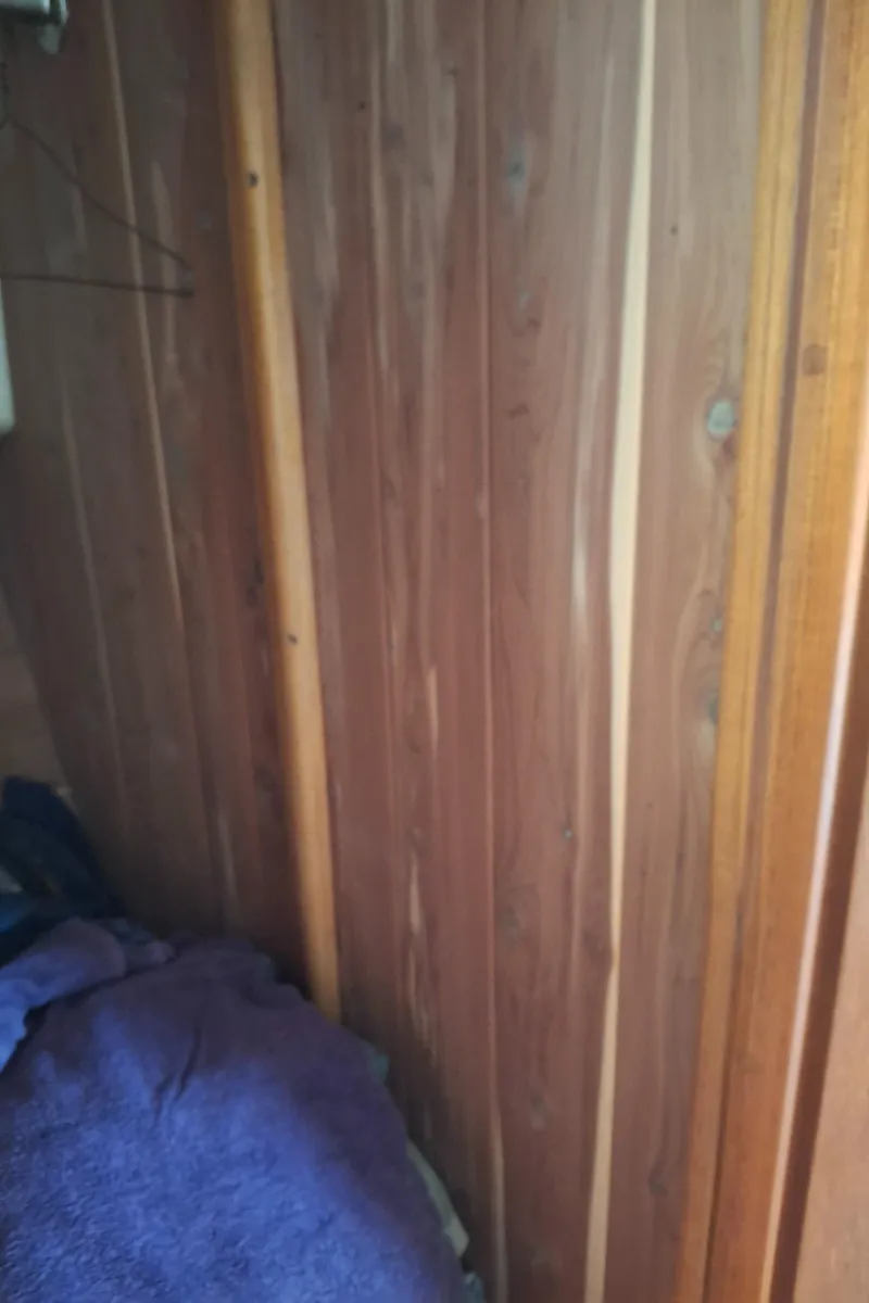 Slide: The Image of Wood-paneled interior of a 2003 Duffy 35 Downeast Flybridge Cruiser with a purple blanket. - 16