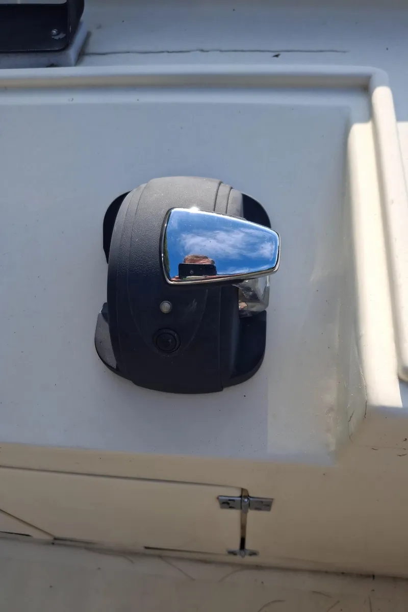 Slide: The Image of Throttle control on 2003 Duffy 35 Downeast Flybridge Cruiser, reflecting blue sky. - 23