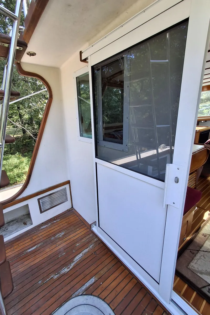 Slide: The Image of 2003 Duffy 35 Downeast Flybridge Cruiser with wooden deck and sliding door. - 27