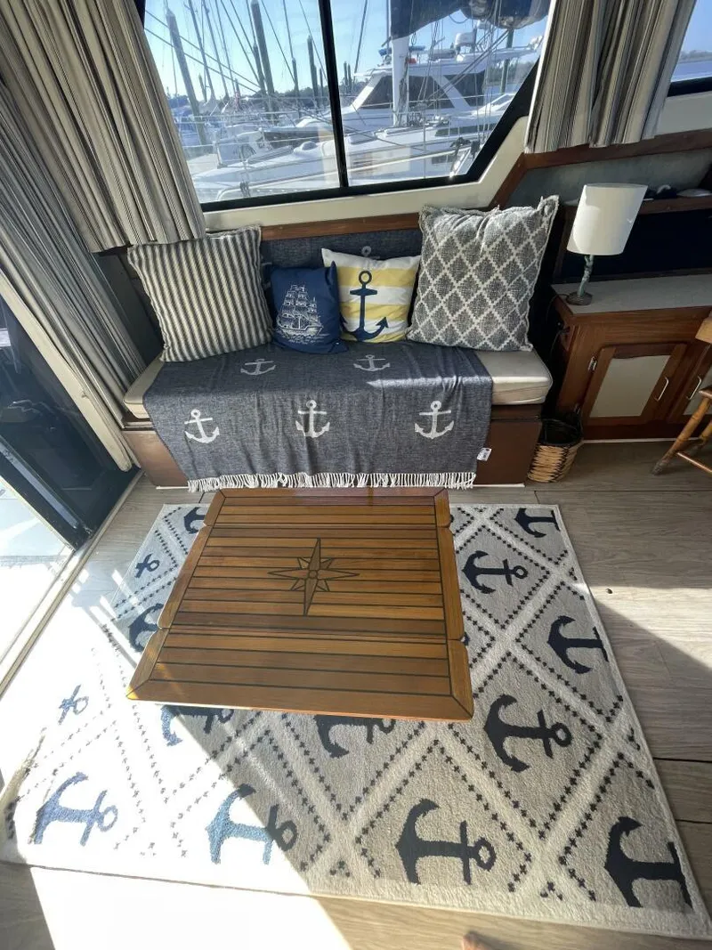 Slide: The Image of Cozy 1984 Mainship MK III interior with nautical-themed decor and anchor-patterned accents. - 10