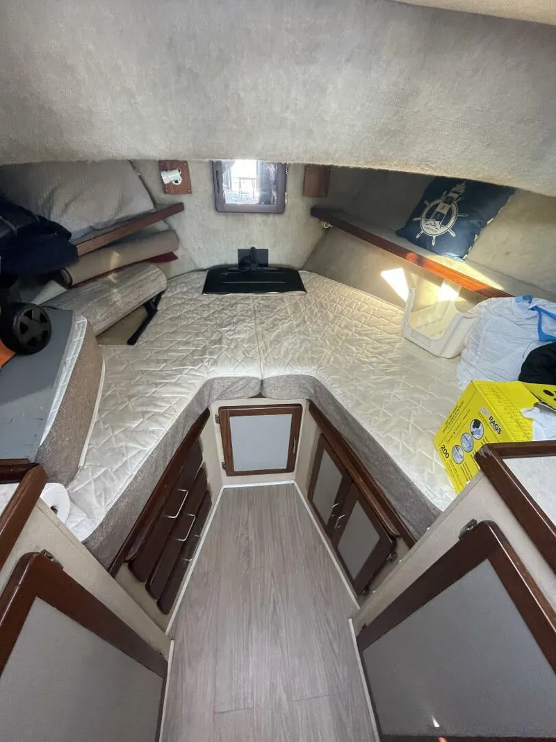 Slide: The Image of Cozy cabin interior of 1984 Mainship MK III with bed and storage cabinets. - 18