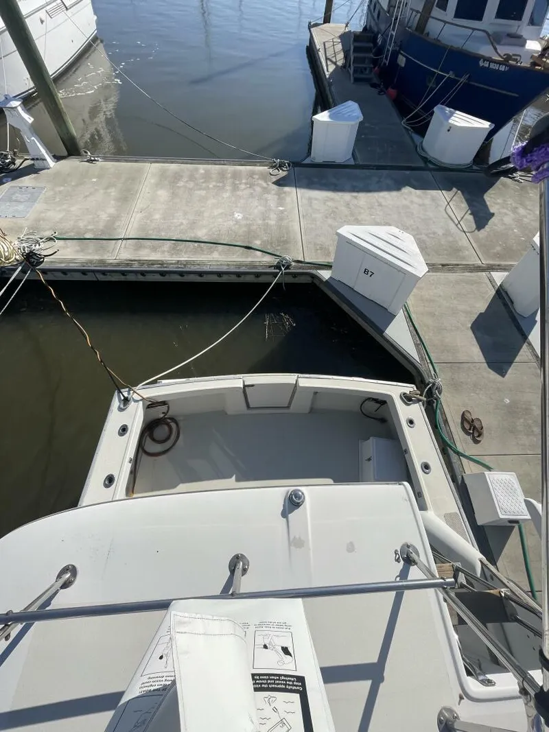 Slide: The Image of 1984 Mainship MK III docked at marina, viewed from above. - 21