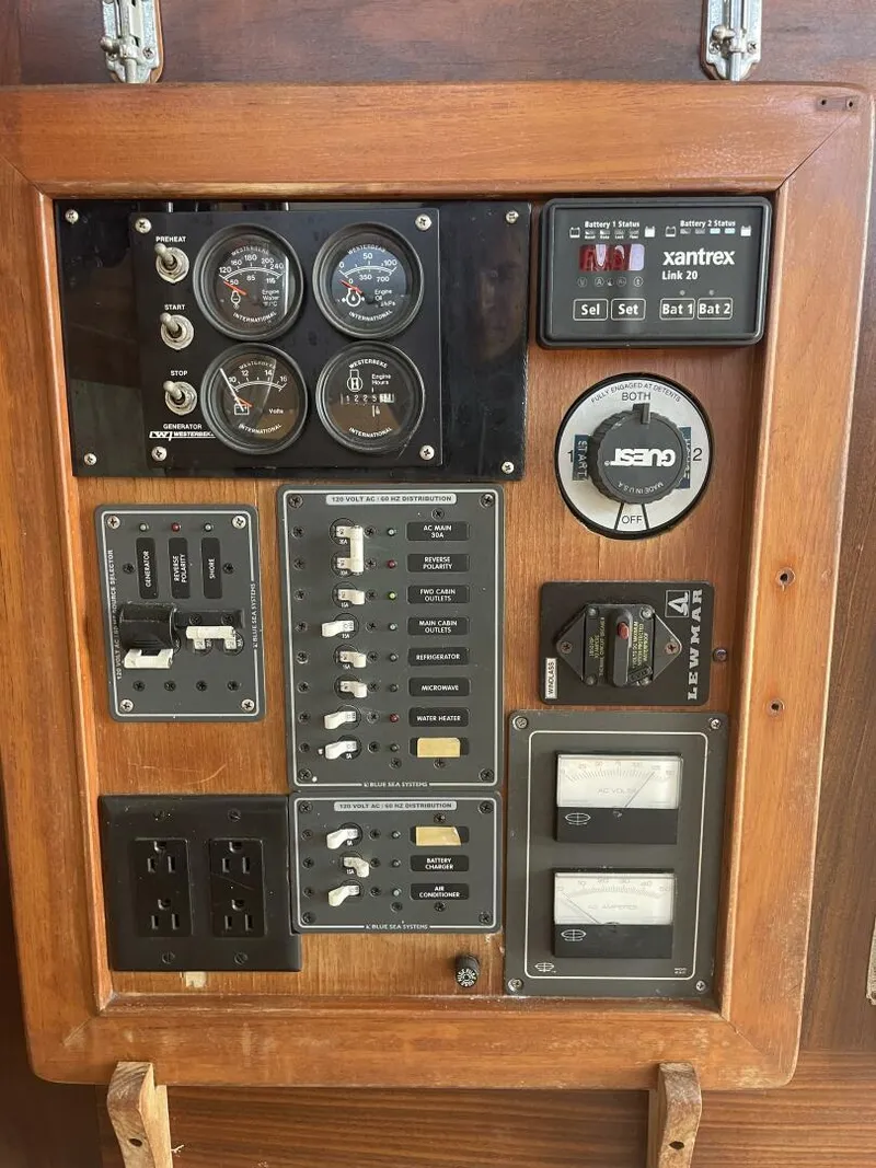Slide: The Image of Control panel of a 1984 Mainship MK III boat with gauges and switches. - 26