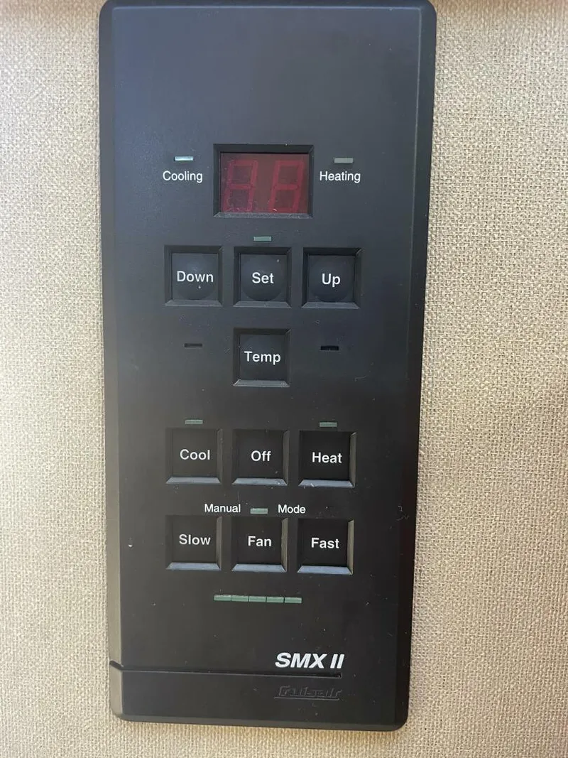 Slide: The Image of Control panel of a 1984 Mainship MK III boat, featuring temperature and fan settings. - 27