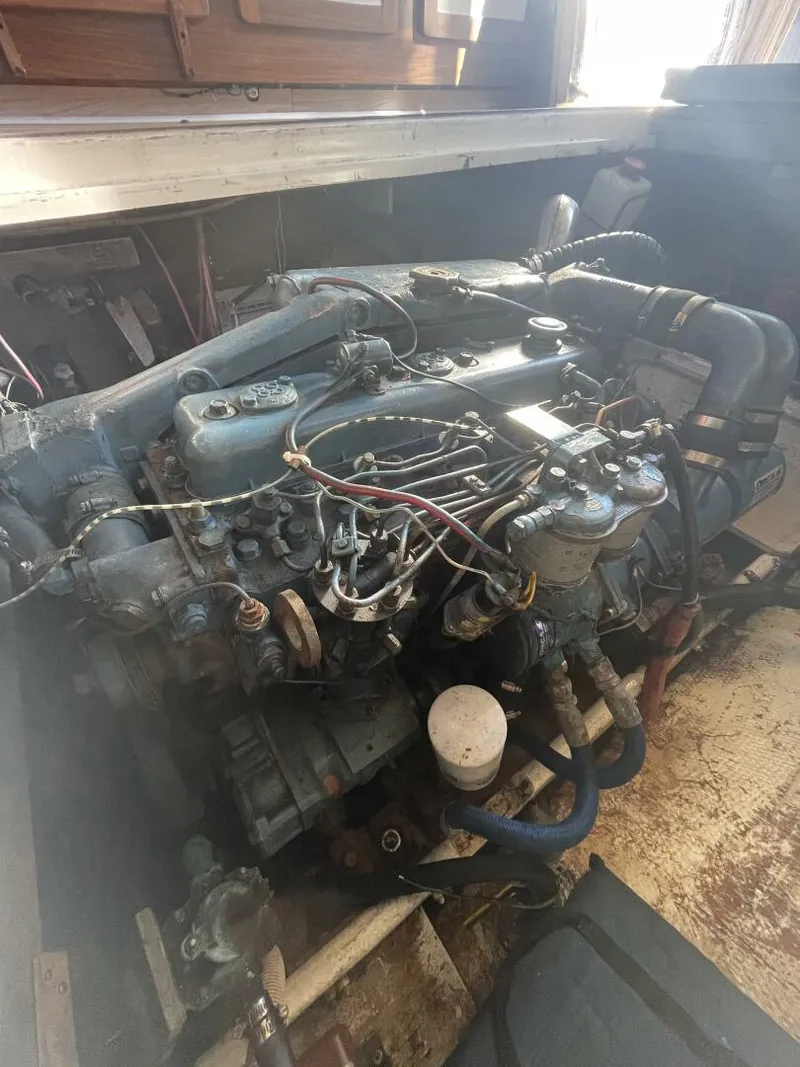 Slide: The Image of 1984 Mainship MK III engine compartment with visible wiring and components. - 29