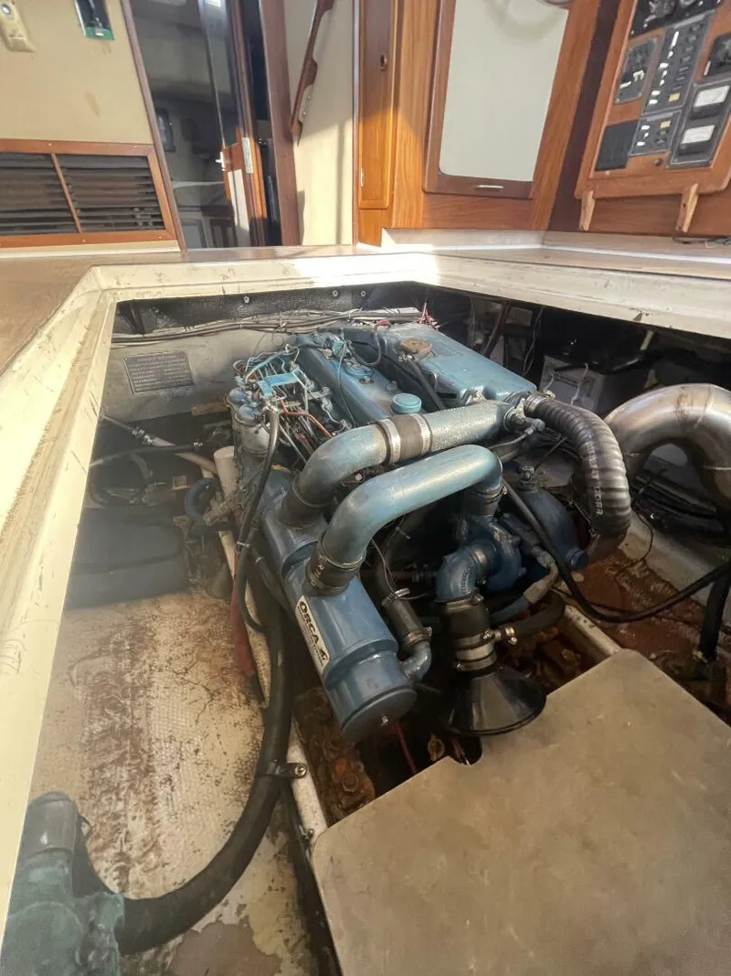 Slide: The Image of Engine room of a 1984 Mainship MK III boat, showcasing the engine and interior details. - 30