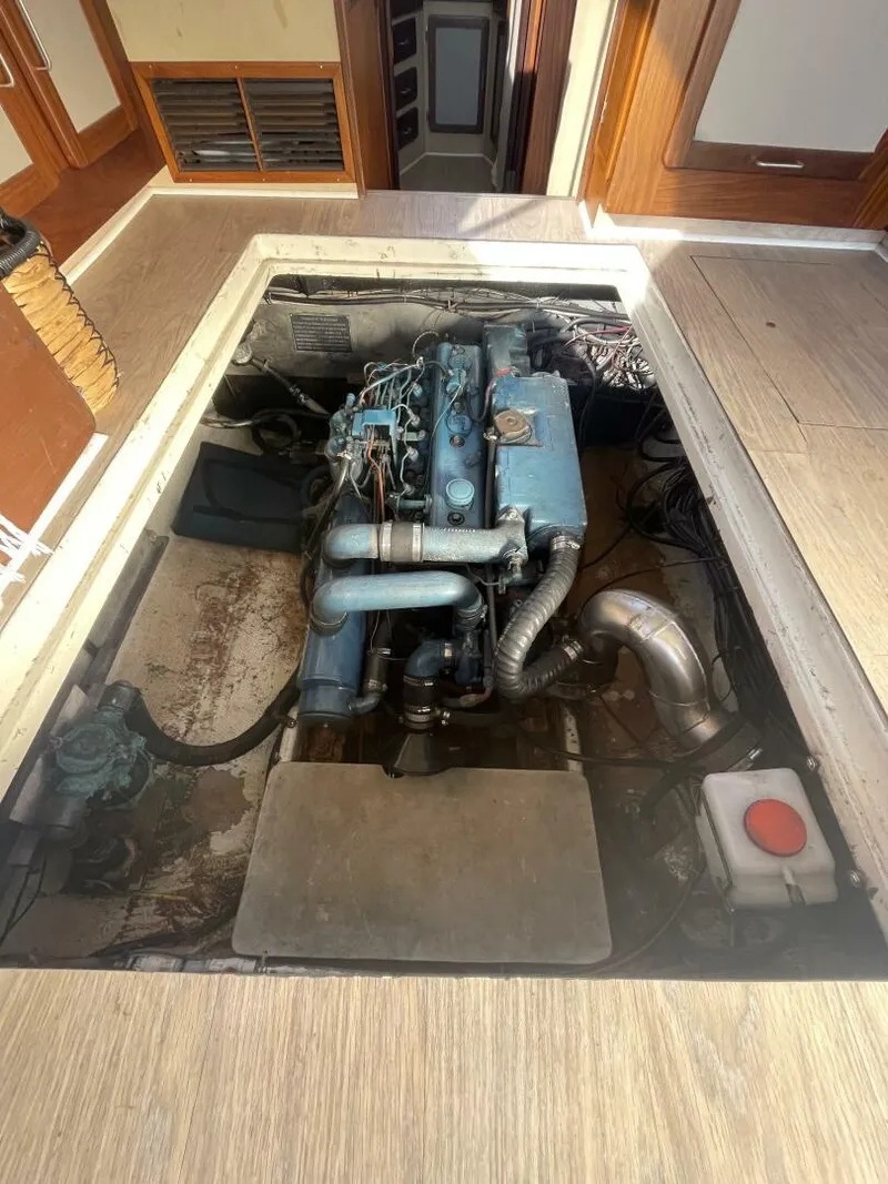 Slide: The Image of Engine compartment of a 1984 Mainship MK III boat, showcasing the engine and surrounding area. - 32