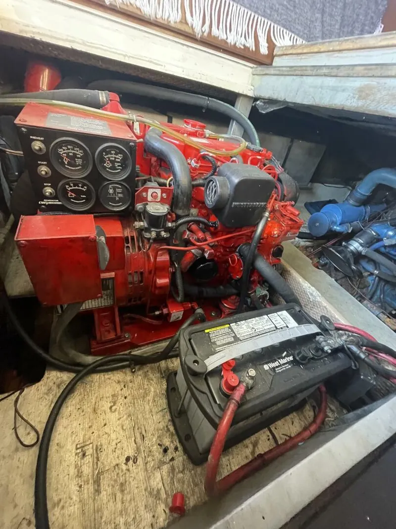 Slide: The Image of Engine compartment of a 1984 Mainship MK III with visible battery and gauges. - 33