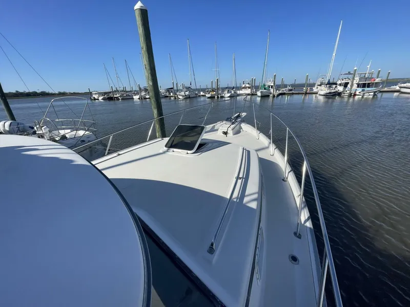 Slide: The Image of 1984 Mainship MK III boat docked at a marina with clear blue skies. - 35