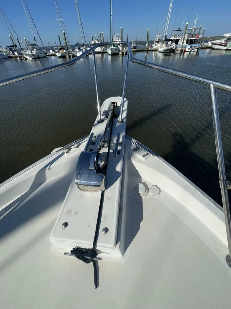 Slide: The Image of 1984 Mainship MK III boat bow with anchor, docked in marina. - 36