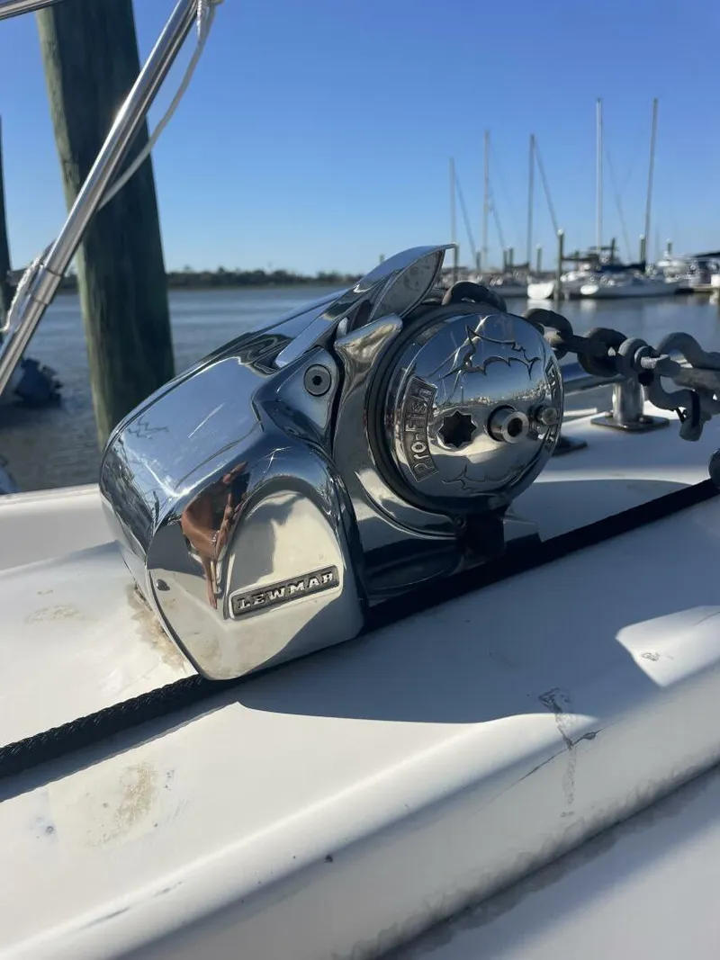 Slide: The Image of Chrome boat winch on 1984 Mainship MK III, docked with sailboats in background. - 37