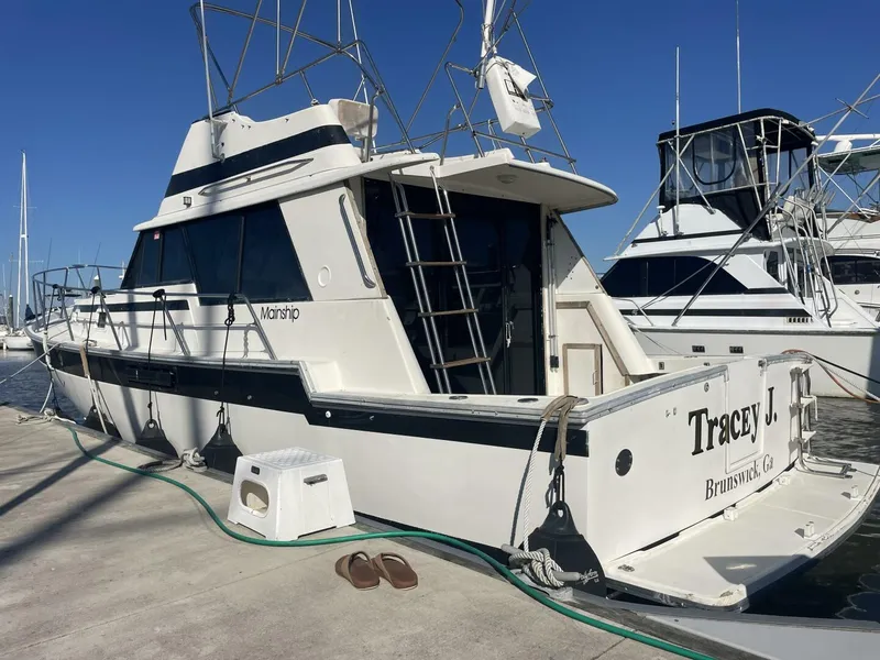 Slide: The Image of 1984 Mainship MK III boat docked at marina under clear blue sky. - 4