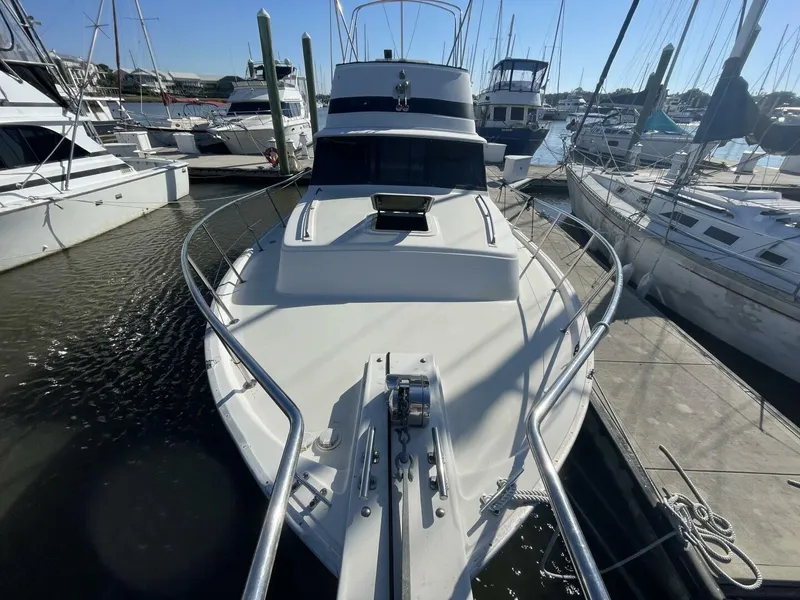 Slide: The Image of 1984 Mainship MK III boat docked at marina, surrounded by other vessels. - 5