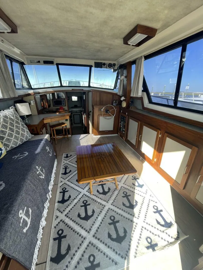 Slide: The Image of Interior of a 1984 Mainship MK III boat with nautical decor and wooden furnishings. - 7