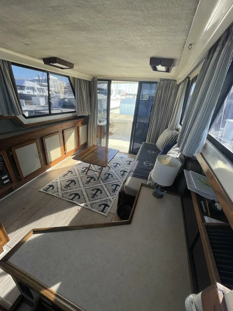 Slide: The Image of Interior of 1984 Mainship MK III boat with nautical decor and large windows. - 8