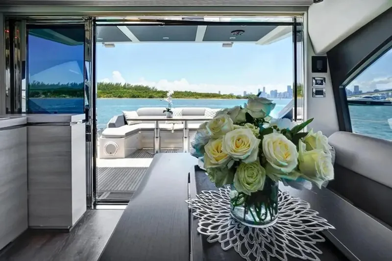Slide: The Image of Luxurious interior of 2015 Azimut 55S yacht with elegant floral arrangement and scenic ocean view. - 10