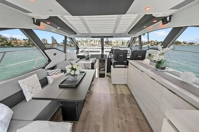 Slide: The Image of Luxurious interior of a 2015 Azimut 55S yacht with elegant seating and scenic views. - 12