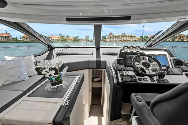 Slide: The Image of Luxurious 2015 Azimut 55S yacht interior with modern helm and scenic waterfront view. - 13