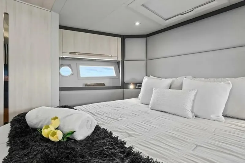 Slide: The Image of Luxurious bedroom interior of 2015 Azimut 55S yacht with elegant bedding and window view. - 16