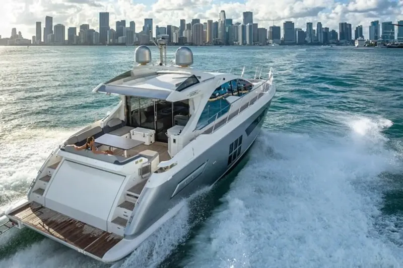 Slide: The Image of 2015 Azimut 55S yacht cruising near city skyline on a sunny day. - 2