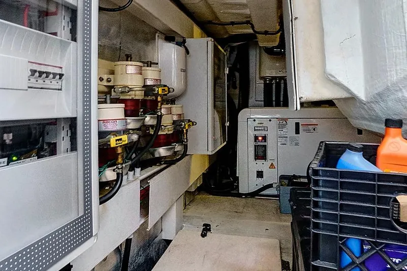 Slide: The Image of Engine room of a 2015 Azimut 55S yacht, featuring technical equipment and storage. - 25