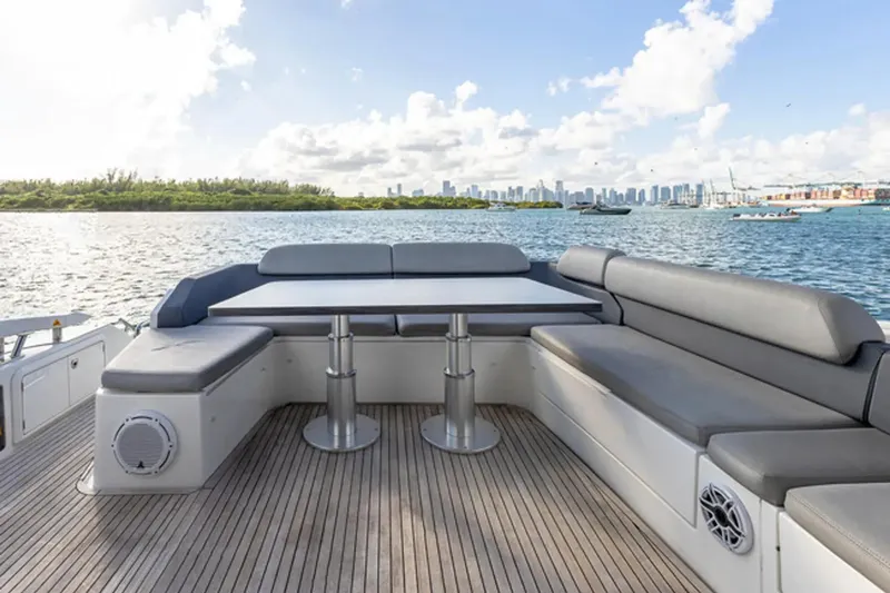 Slide: The Image of 2015 Azimut 55S yacht deck with seating, table, and scenic waterfront view. - 5