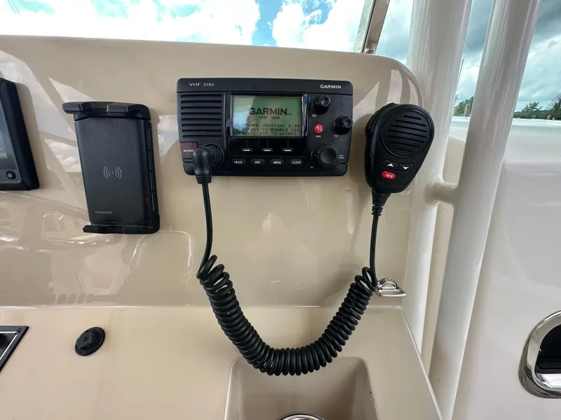 Slide: The Image of Control panel of 2015 Pursuit ST 310 Sport with Garmin VHF 200 radio and microphone. - 15