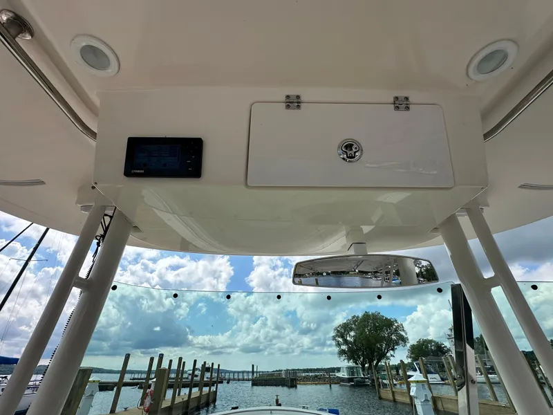 Slide: The Image of 2015 Pursuit ST 310 Sport boat interior with dock view and Yamaha display. - 16
