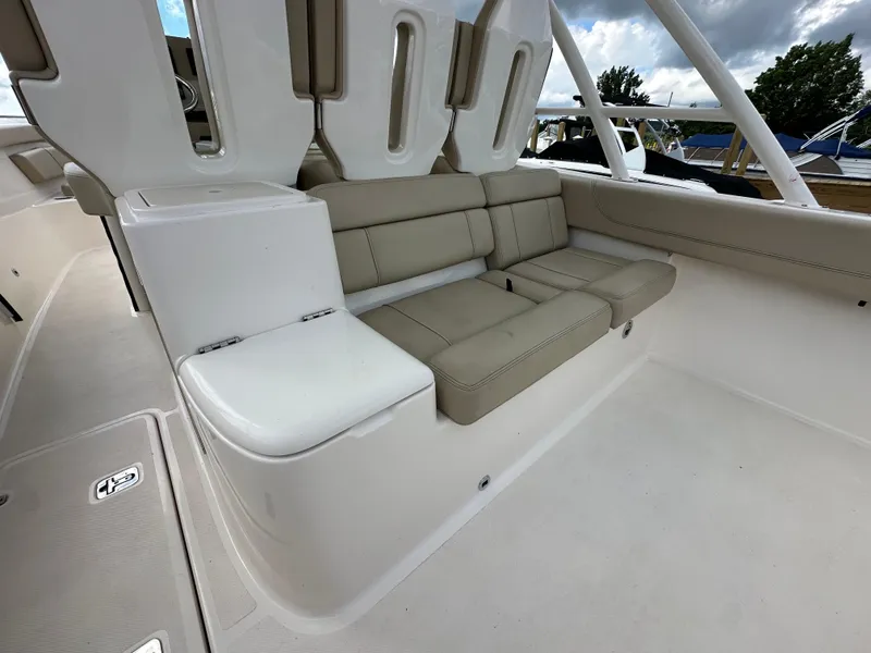 Slide: The Image of 2015 Pursuit ST 310 Sport boat interior with beige seating and white deck. - 20