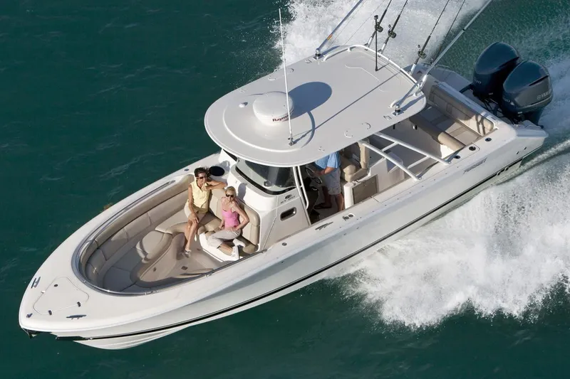 Slide: The Image of Manufacturer Provided Image: 2015 Pursuit ST 310 Sport boat cruising on water with passengers. - 25